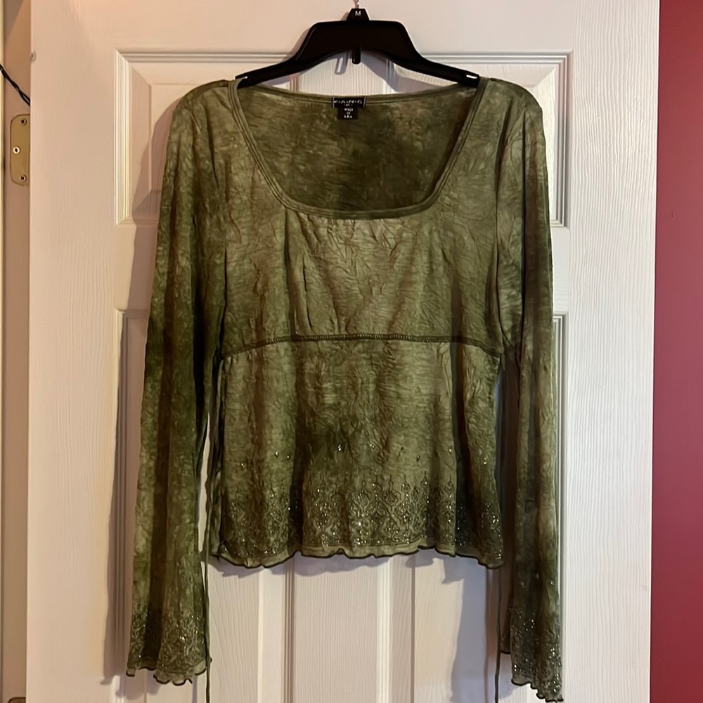 green low cut shirt. flare arms with sparkles and a tie around. super cute on!
